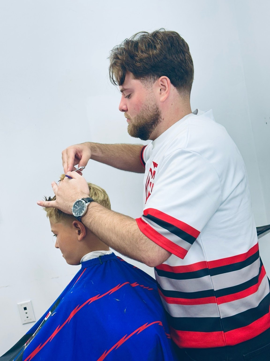 Barber Spencer Mihalis cutting hair at PN Barbershop