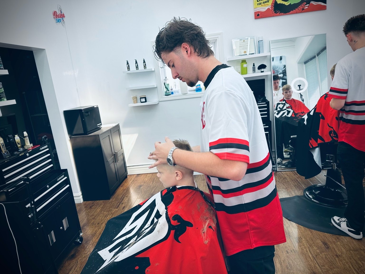 Barber James Graham cutting hair at PN Barbershop